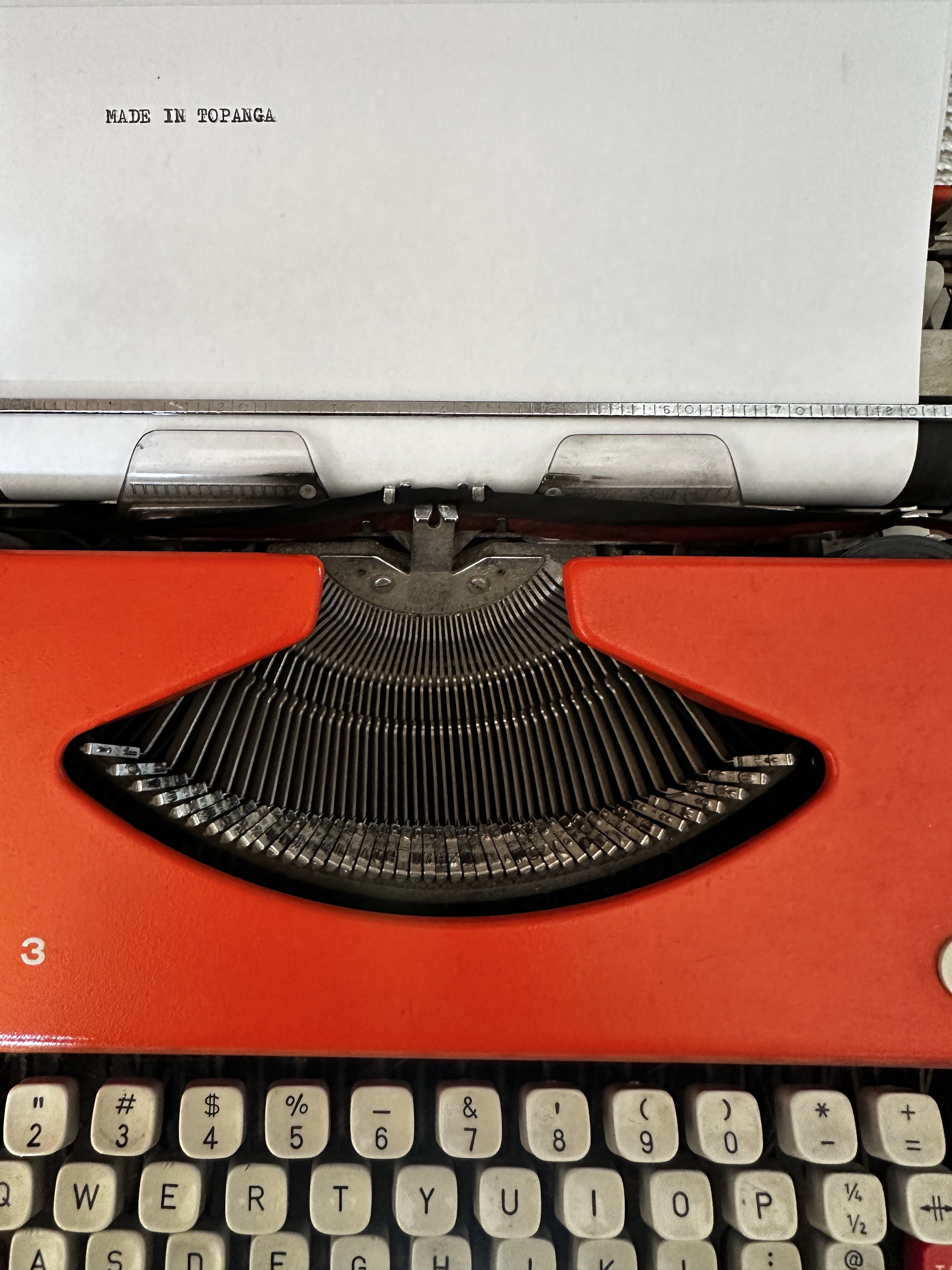 Made in Topanga typed on a red typewriter